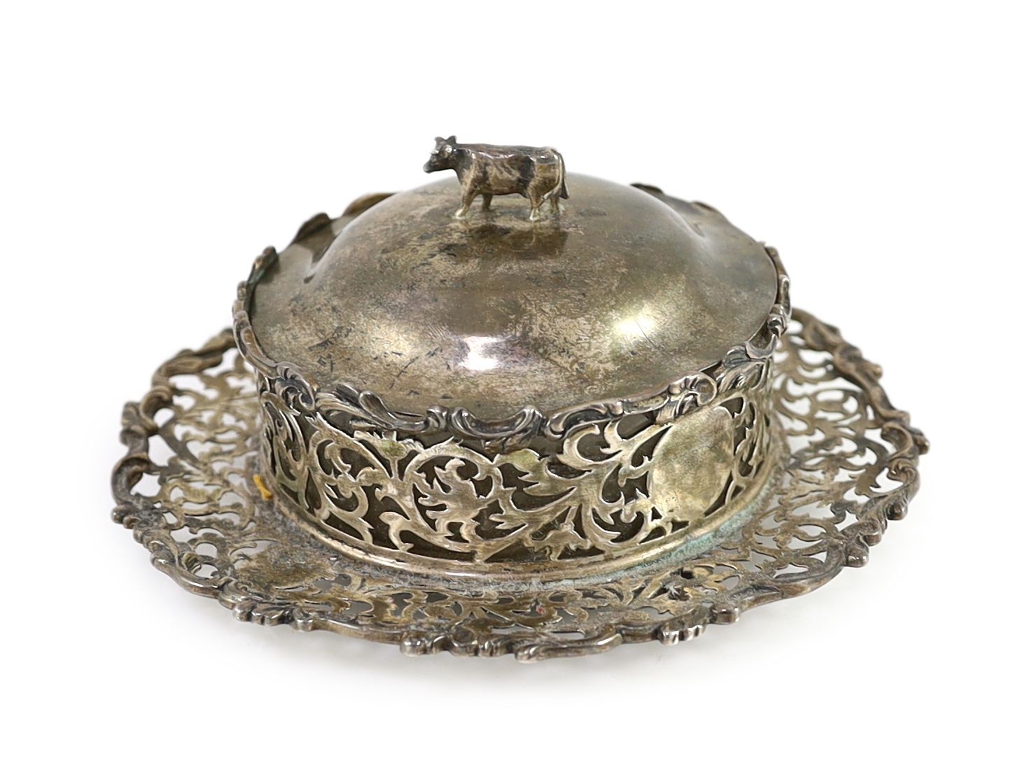 An Edwardian pierced silver butter dish and cover by Charles Stuart Harris & Sons